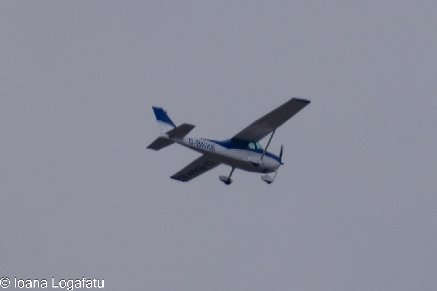 Cessna soaring through the cloudy sky above